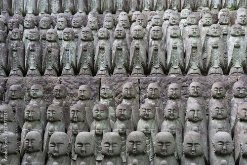 Rows of Jizo stone statues at a Buddhist temple in Kamakura, Japan