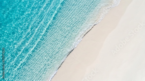 Sticker Aerial view of crystal clear turquoise ocean waves gently washing over white san