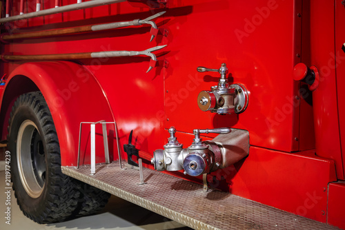 Old classic red fire truck pumper tanker.