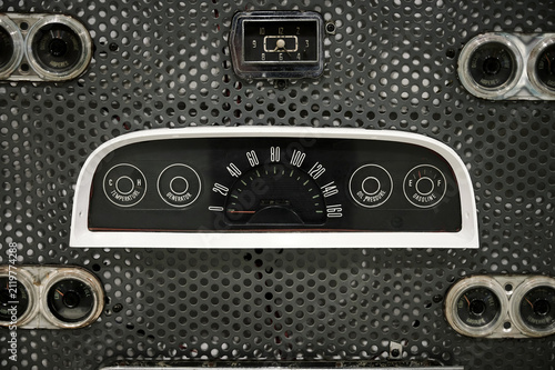 Obraz na plátně Retro car dashboard and gauges on a metal mesh.