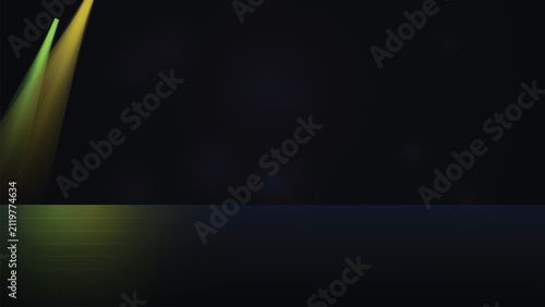 Dual green and yellow spotlight rays on dark abstract background with spotlight