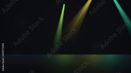 Three angled stage lights with yellow and green beams on dark floor, spotlight