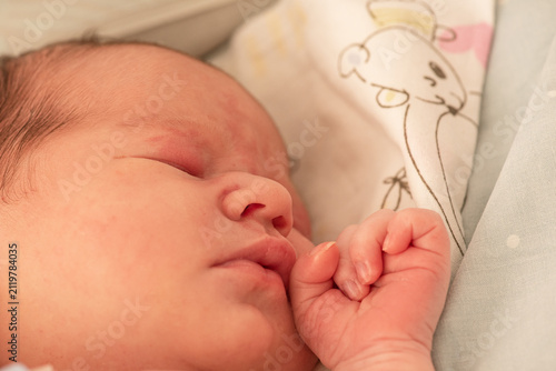 Newborn baby sleeping. Baby in the first hours after birth.