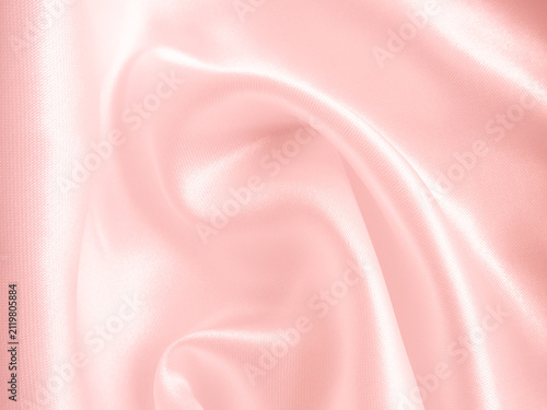 Soft pink silk satin fabric background with gentle folds