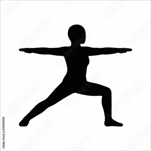 Silhouette of a woman in Warrior II yoga pose.