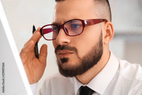 Male trader in eyeglasses w...