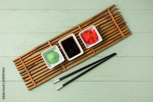 Bowls with wasabi, soy sauc...