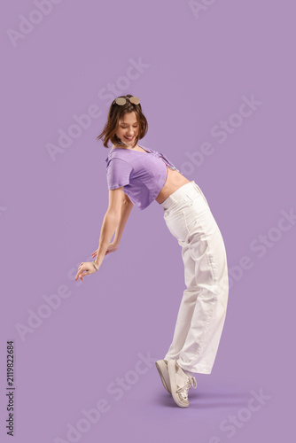 Stylish young woman dancing...