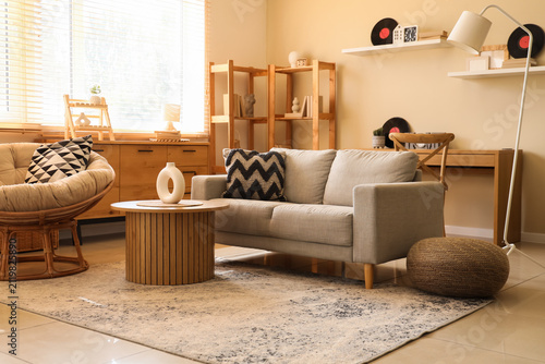 Canvas Print Interior of stylish living room with sofa, armchair and vinyl disks