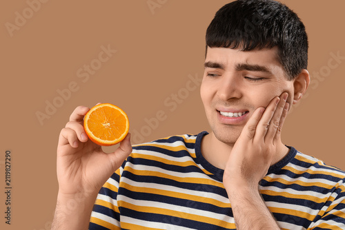 Young man with orange suffe...