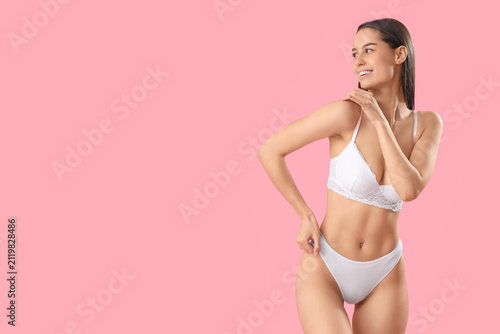 Slim young woman in white u...