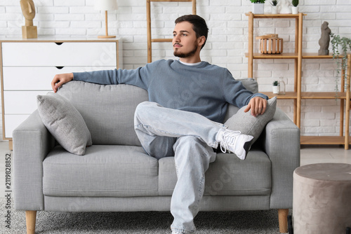 Handsome young man sitting ...
