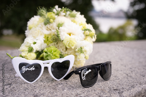 Bridal bouquet and sunglasses for the bride and groom.