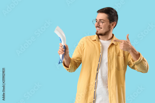 Happy young man pointing at...