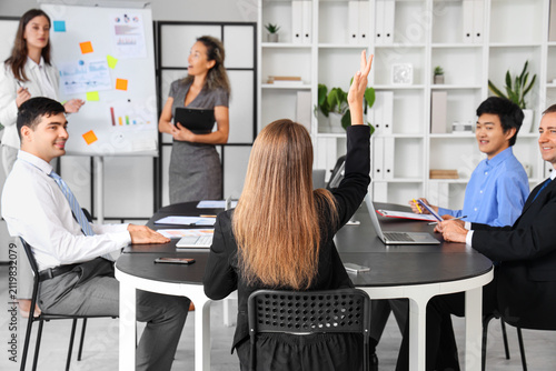 Group of business people having meeting in office, back view