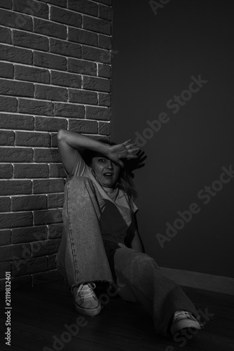 Scared mature woman sitting...