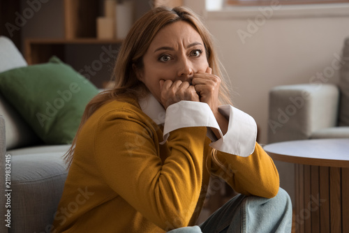 Scared mature woman at home