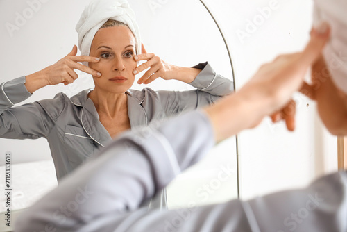 Mature woman doing face bui...