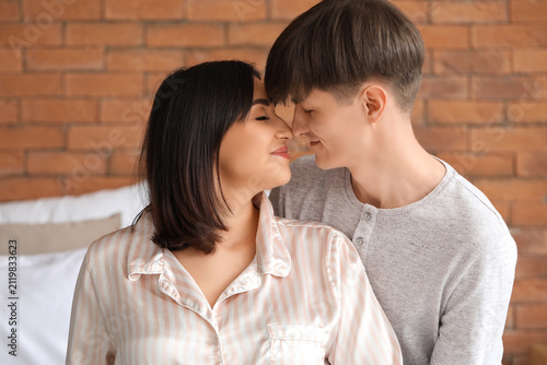 Young pregnant couple in be...
