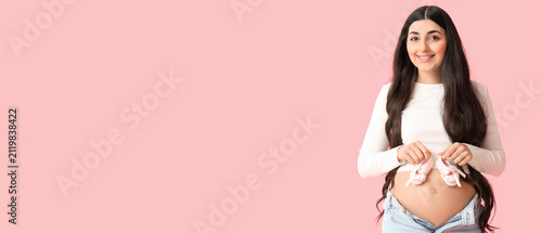 Smiling pregnant woman hold...