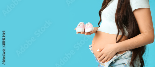 Pregnant woman holding tiny...