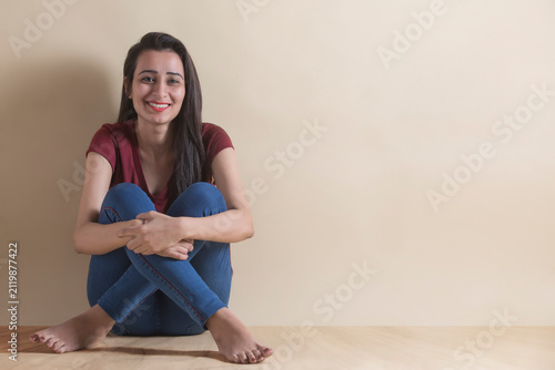 Happy young girl sitting in joy