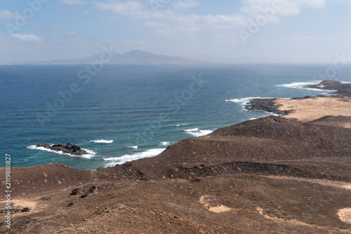Panoramic view from Caldera Mountain on Lobos Island. Lanzarote in the background. Fuerteventura, Canary Islands