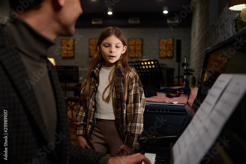 Studio with girl and teacher practicing instruments