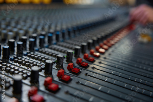 Elegant studio scene highlighting sophisticated audio mixer with textured knobs