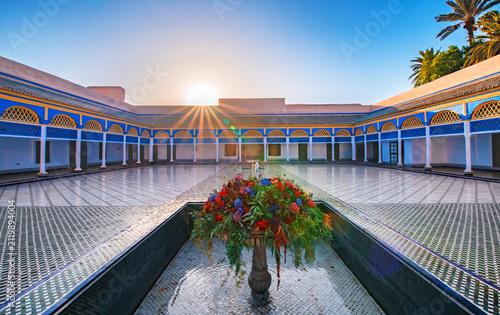 Sunburst over Bahia Palace courtyard with traditional Moroccan architecture Marrakech Morocco