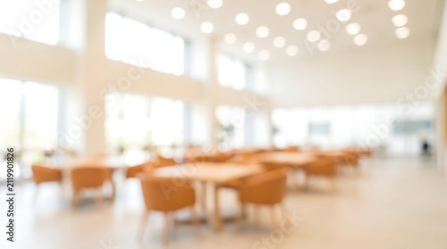 Sunlit modern office cafeteria with tables and chairs in a blurred background setting perfect for corporate wellness and employee break room concepts in a clean professional environment