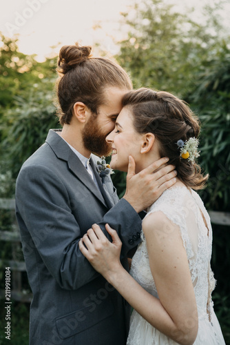 Happy affectionate bride and groom outdoors