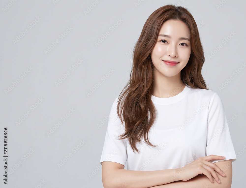 Obraz premium A beautiful young Asian woman in a white shirt smiling warmly
