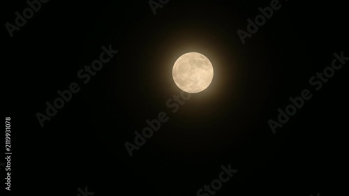 The July Full Moon is known as the ''Buck Moon'' in Native American tradition, coinciding with Guru Purnima. See black storm clouds, tree branches, electric wire, and construction, lunar corona