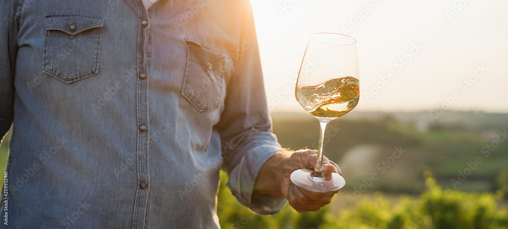 Obraz premium Wine producer mane tasting the product after harvest and grape fermentation process - Vinification, organic quality product and small business concept - Main focus on glass