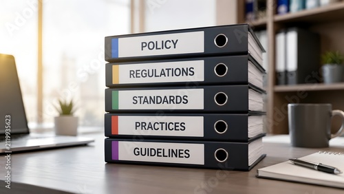 Corporate governance framework showing stack of compliance binders with policy regulations and business standards in a modern office