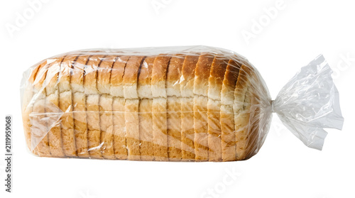 Freshly sliced white sandwich bread loaf in plastic wrap. Soft bakery bread cut for sandwiches and toast preparation.