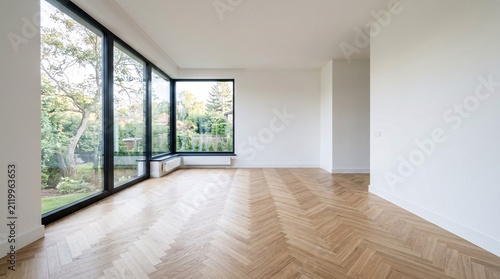Canvas Print Minimalist sunlit interior with wide wood herringbone floors.