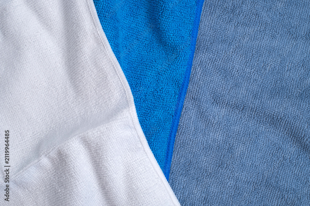 Fototapeta premium Blue, grey and white microfiber towels for cleaning and home textile concept