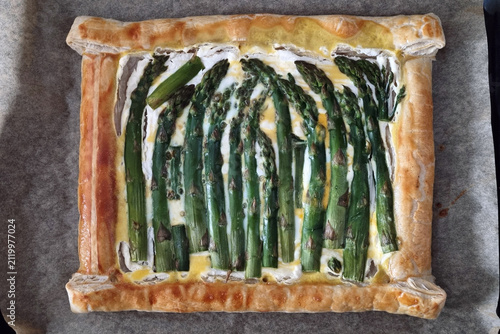 Rustic Asparagus Tart with Creamy Cheese Filling on Parchment Paper for Culinary Inspiration