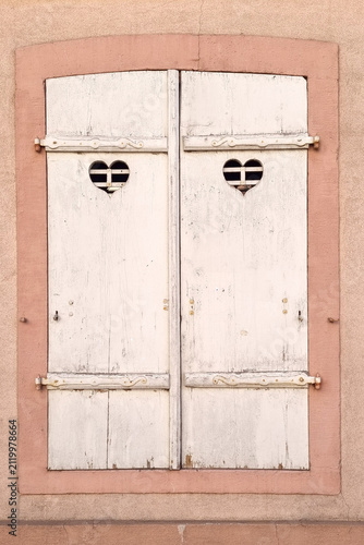 Vintage Wooden Shuttered Window with Heart Cutouts for Rustic Home Decor or Travel Photography