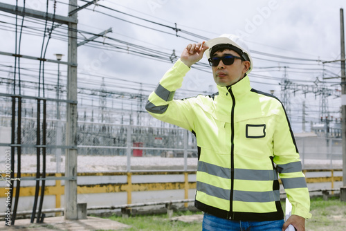 Canvas Print Engineer or electrical technician inspecting an outdoor power substation
