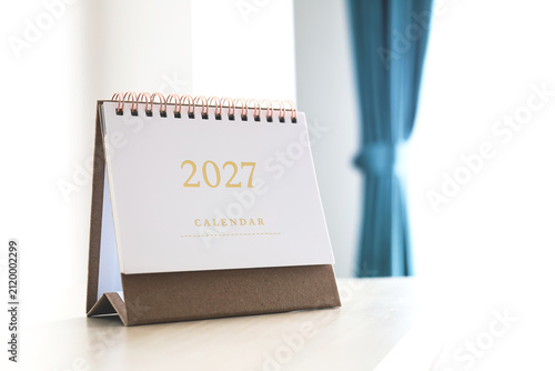2027 desk calendar with gold numbers on craft paper base. Concept of new year resolution, annual planning, and time management.