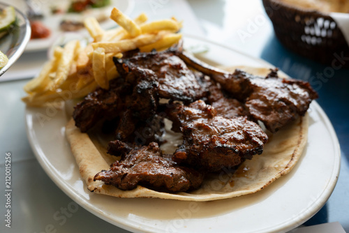Grilled Lamb Chops Served with French Fries on Pita Bread in Doha Restaurant