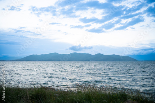 Wavy Lake Water Surface looking across to Mountain Silhouette at Dusk