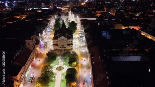 Night aerial footage of the historic center of Kosice, Slovakia, showing St. Elisabeth Cathedral, the Urban Tower and the city’s main square. The drone view highlights the illuminated Gothic landmark 