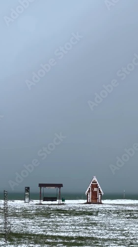 winter seascape with vast blue sky and swing near the coast creating peaceful outdoor scenery concept of winter travel seaside recreation tourism and relaxation