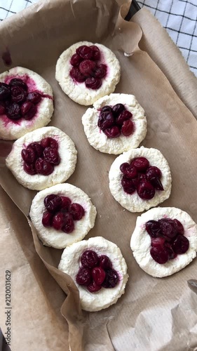 preparing cottage cheese flatbreads with cherries for baking showing fresh ingredients and homemade dessert preparation concept of healthy cooking recipes bakery and food styling