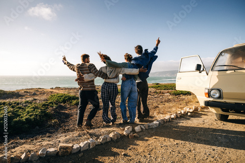 Friends celebrate a fun moment together on their road trip
