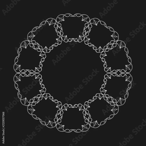 Vintage calligraphic round frame. Elegant white filigree wreath with ornate scrollwork flourishes arranged in a circular ring isolated on a black background
